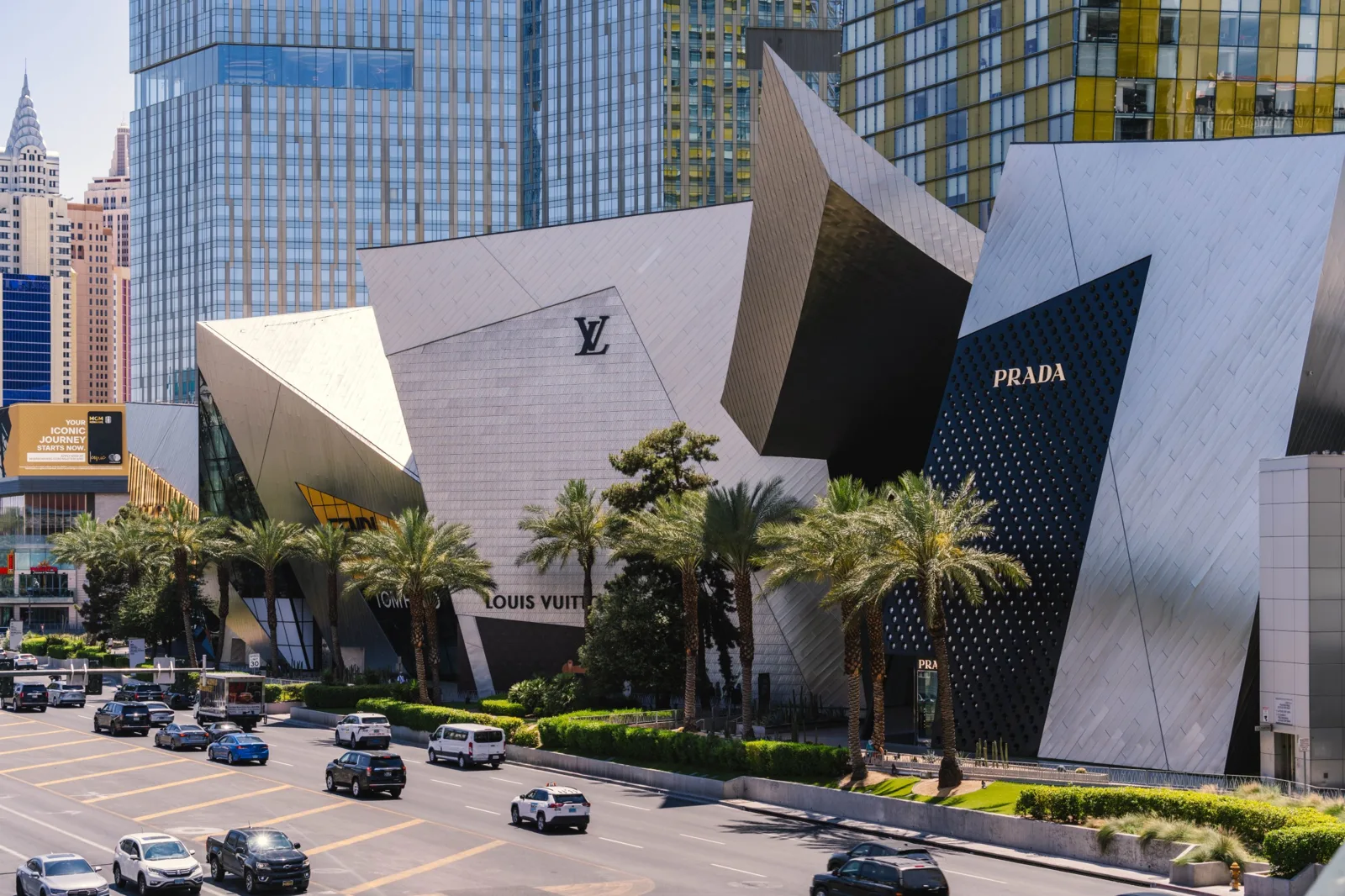 Shoppers and traffic outside a modern retail precinct