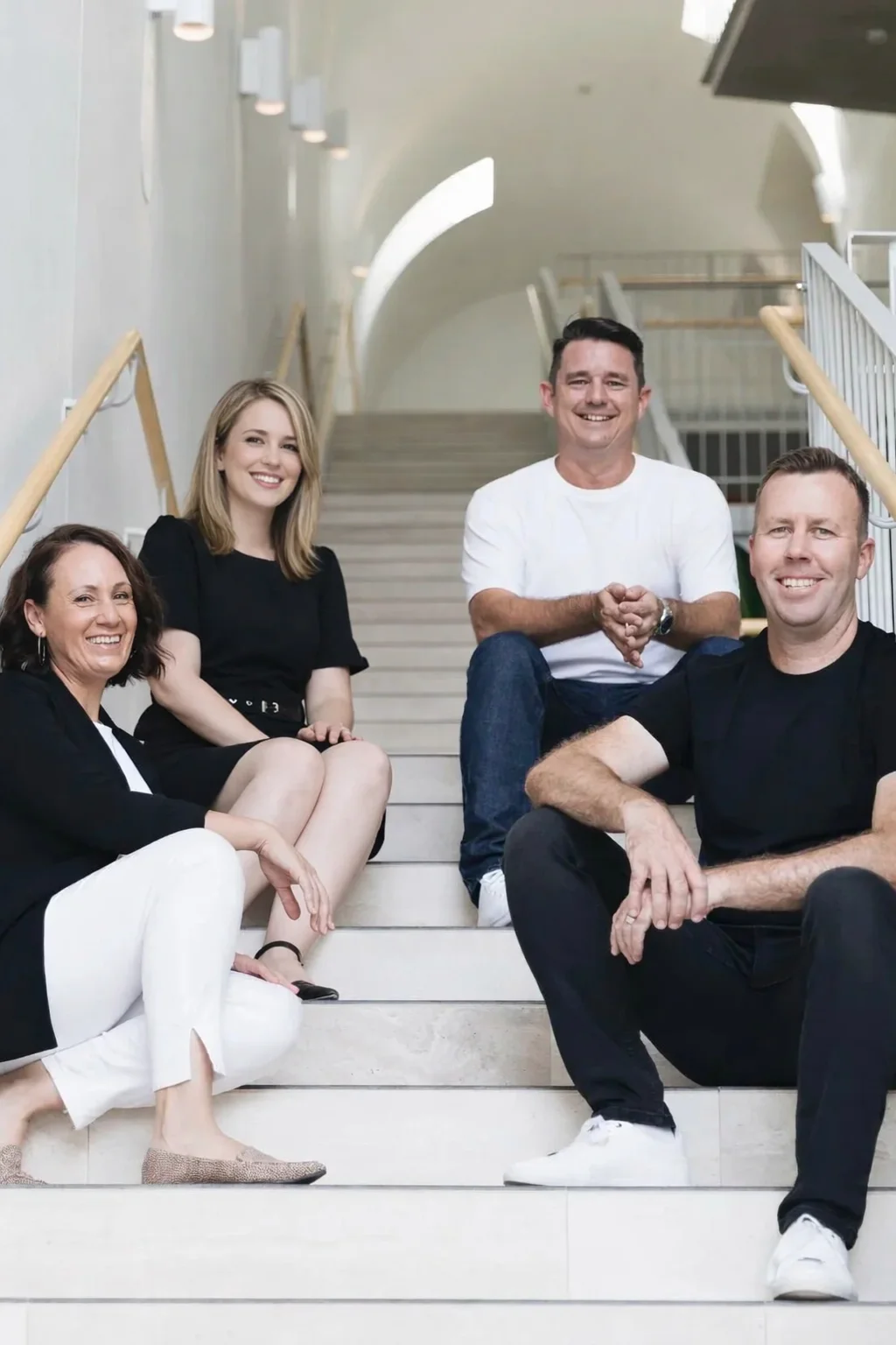 The Base Digital team sitting together on a staircase